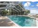 Enclosed pool featuring a relaxing spa and lake view that creates a perfect private retreat and endless hours of enjoyment at 250 Brigham Nw Rd, Winter Haven, FL 33881
