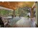Spacious screened porch featuring wood flooring, ceiling fan, and scenic views of the backyard and waterfront at 250 Brigham Nw Rd, Winter Haven, FL 33881