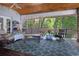 Inviting screened porch with cozy seating, wood flooring, and views of a tranquil outdoor setting at 250 Brigham Nw Rd, Winter Haven, FL 33881