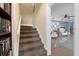 Carpeted staircase that leads to the landing and a view of the living area at 250 Brigham Nw Rd, Winter Haven, FL 33881