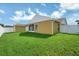 The fenced backyard offers a green lawn and metal storage shed behind the house at 251 Kings Pond Ave, Winter Haven, FL 33880