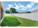 A spacious backyard showing the manicured lawn and privacy fence at 251 Kings Pond Ave, Winter Haven, FL 33880