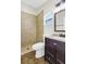Bathroom featuring a stand-up shower with decorative tile, dark cabinetry, and sleek fixtures at 251 Kings Pond Ave, Winter Haven, FL 33880