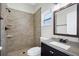 Updated bathroom with granite countertop vanity, tile shower, and modern fixtures at 251 Kings Pond Ave, Winter Haven, FL 33880
