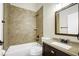 Updated bathroom featuring a bathtub, shower, dark cabinetry, granite countertop, and modern fixtures at 251 Kings Pond Ave, Winter Haven, FL 33880