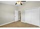 Bedroom with ceiling fan, carpeted floor, double door closet, and white doors at 251 Kings Pond Ave, Winter Haven, FL 33880