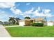 Well-kept single-story home with lush green lawn, attached garage, and manicured shrubbery at 251 Kings Pond Ave, Winter Haven, FL 33880