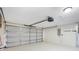 Spacious two car garage with neutral painted floor, overhead lighting, and utility panel at 251 Kings Pond Ave, Winter Haven, FL 33880