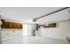 Garage showing the water heater, cabinets and door leading to the home's interior at 251 Kings Pond Ave, Winter Haven, FL 33880