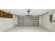 Spacious two car garage with painted floor, overhead lighting, and ample storage space at 251 Kings Pond Ave, Winter Haven, FL 33880
