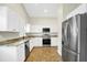 Bright kitchen with stainless steel appliances, granite countertops, and ample white cabinet space at 251 Kings Pond Ave, Winter Haven, FL 33880