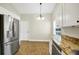 Open kitchen area featuring stainless steel appliances, granite counters and adjacent dining space at 251 Kings Pond Ave, Winter Haven, FL 33880
