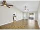 Open-concept living area featuring tile flooring, a sliding glass door, and access to the kitchen at 251 Kings Pond Ave, Winter Haven, FL 33880
