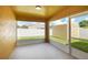 Enclosed patio with neutral color walls and flooring provides an enjoyable place to relax outdoors at 251 Kings Pond Ave, Winter Haven, FL 33880