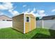 Outdoor metal storage shed with white trim offers extra room for storage on property at 251 Kings Pond Ave, Winter Haven, FL 33880