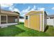 Side view of the storage shed with a secure door on the property at 251 Kings Pond Ave, Winter Haven, FL 33880