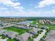 Aerial view of community showing homes, lake, and green spaces at 2824 Attwater Loop, Winter Haven, FL 33884