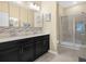 Clean bathroom with double vanity sinks and glass shower at 2824 Attwater Loop, Winter Haven, FL 33884