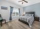 Cozy bedroom with wood floors, bright natural light, and stylish decor at 2824 Attwater Loop, Winter Haven, FL 33884