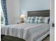 Comfortable bedroom with window, bedside lamp, and decorative pillows at 2824 Attwater Loop, Winter Haven, FL 33884