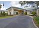 Inviting clubhouse exterior with covered entrance and well-maintained landscaping at 2824 Attwater Loop, Winter Haven, FL 33884