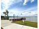 Community dock stretching into the lake, surrounded by lush greenery at 2824 Attwater Loop, Winter Haven, FL 33884