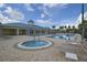 Beautiful community pool and hot tub area surrounded by lush greenery and lounging chairs at 2824 Attwater Loop, Winter Haven, FL 33884