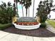 Community sign for Traditions surrounded by beautiful landscaping at 2824 Attwater Loop, Winter Haven, FL 33884