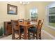 A dining area featuring a wood table and chairs with natural light at 2824 Attwater Loop, Winter Haven, FL 33884