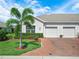 Villa with a two-car garage, brick paved drive and beautiful landscaping at 2824 Attwater Loop, Winter Haven, FL 33884