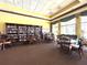 Relax in the clubhouse library with ample seating, tables, and shelves full of books at 2824 Attwater Loop, Winter Haven, FL 33884