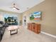 Spacious living room with a ceiling fan and sliding door to a lanai at 2824 Attwater Loop, Winter Haven, FL 33884