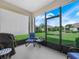 Relaxing screened porch with a chair and table overlooking the backyard at 2824 Attwater Loop, Winter Haven, FL 33884