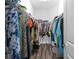 Spacious walk-in closet featuring ample storage and wood-look flooring at 2824 Attwater Loop, Winter Haven, FL 33884