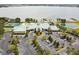 Aerial view of lakeside clubhouse amenities including a pool, tennis courts, and ample parking at 2980 Dayton Dr, Winter Haven, FL 33884