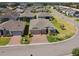 Aerial view of a well-maintained home and landscaping on a quiet street at 2980 Dayton Dr, Winter Haven, FL 33884
