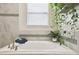 Bathroom featuring a soaking tub with modern fixtures and natural light, creating a serene atmosphere at 2980 Dayton Dr, Winter Haven, FL 33884