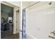 Bathroom features a tub and shower, with a neutral-colored shower curtain at 2980 Dayton Dr, Winter Haven, FL 33884