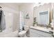 Well-lit bathroom featuring a tub, shower, and a classic vanity at 2980 Dayton Dr, Winter Haven, FL 33884