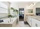 Elegant bathroom featuring a soaking tub, double vanity, and indoor plants offering a spa-like experience at 2980 Dayton Dr, Winter Haven, FL 33884