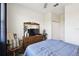 Comfortable bedroom with a traditional wooden dresser, ceiling fan, and a cozy rocking chair at 2980 Dayton Dr, Winter Haven, FL 33884