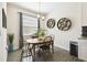Bright dining area with a wood table, charming decor, and ample natural light at 2980 Dayton Dr, Winter Haven, FL 33884