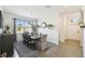 Well-lit dining room features a wooden table, stylish decor, and a large window with natural light at 2980 Dayton Dr, Winter Haven, FL 33884