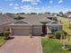 Beautiful single-story home featuring a three-car garage, brick driveway, and well-manicured landscaping at 2980 Dayton Dr, Winter Haven, FL 33884