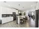 Modern kitchen with white cabinets, stainless steel appliances, and an island with bar seating at 2980 Dayton Dr, Winter Haven, FL 33884