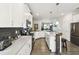Modern kitchen featuring stainless steel appliances, gray backsplash and countertops, and wood look tile flooring at 2980 Dayton Dr, Winter Haven, FL 33884