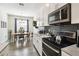 Cozy kitchen with stainless steel appliances, white cabinets, and an adjoining dining area at 2980 Dayton Dr, Winter Haven, FL 33884