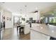 Bright kitchen with stainless steel appliances, pendant lights, tile flooring, and an island at 2980 Dayton Dr, Winter Haven, FL 33884