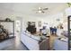 Open concept living room with tile flooring and access to the kitchen, dining, and bathroom at 2980 Dayton Dr, Winter Haven, FL 33884