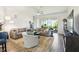 Spacious living room with modern tile floors, neutral-toned furniture, and sliding glass doors to the outdoor living area at 2980 Dayton Dr, Winter Haven, FL 33884